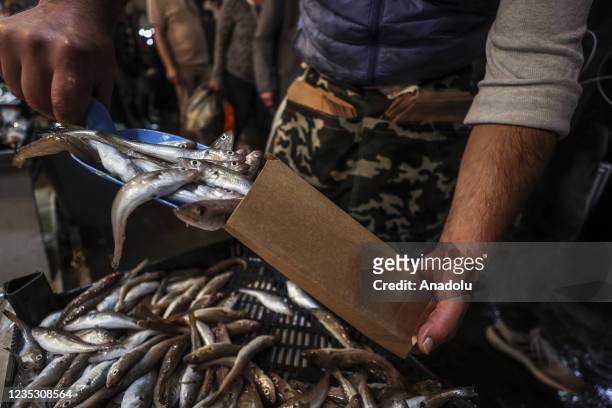 Fishers prepare market stalls in the late night as people show great interest after the beginning of fishing season at the fish market in Ankara,...