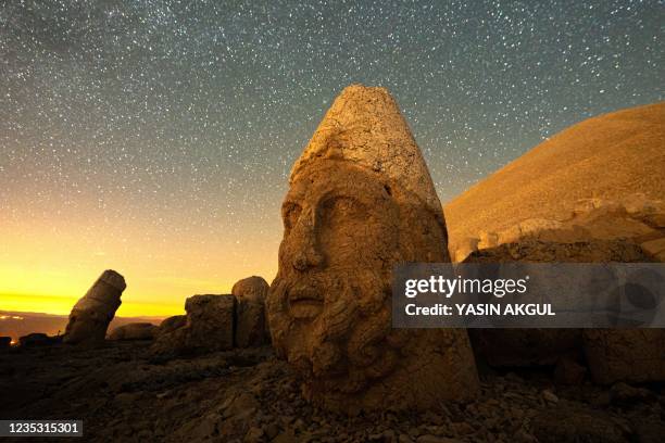 This photograph shows large stone head statues at the archaeological site of Mount Nemrut in Adiyaman, southeastern Turkey, on September 17, 2021. -...
