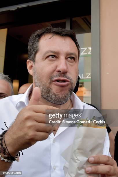 Lega leader Matteo Salvini eats pizza and meets shopkeepers and citizens in the Torre Maura suburban district during the election campaign for the...