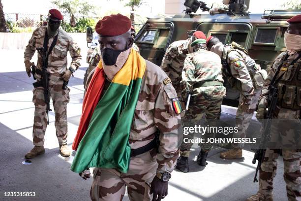 Member of Colonel Mamady Doumbouya's team of Special Forces wears a national Flag as he arrives ahead of a meeting with his team of Special Forces...