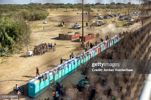 Migrants, mostly from Haiti, gather at a makeshift encampment under the International Bridge on the broder between Del Rio, TX and Acuña, MX on...