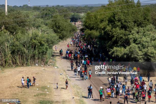 Migrants, mostly from Haiti, gather at a makeshift encampment under the International Bridge on the broder between Del Rio, TX and Acuña, MX on...
