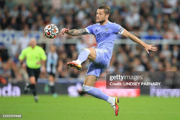 Leeds United's English-born Scottish defender Liam Cooper clears the ball during the English Premier League football match between Newcastle United...