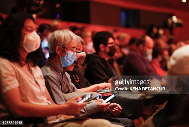 Audience members wear face masks as they attend the New York Philharmonic's first concert after its reopening at the Alice Tully Hall in New York, on...