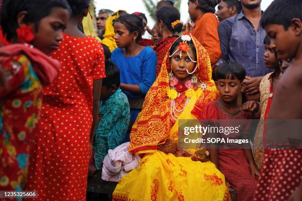 Year old school girl Hafsa sits with friends and neighbors while posing for photos on her wedding day at a village named Joymoni from a coastal area...