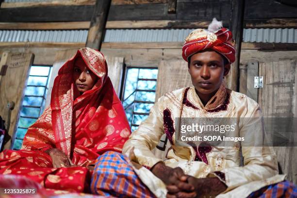 Year old Ibrahim with his new bride, 14 year old Hafsa seen on their wedding day at at a village named Joymoni from a coastal area from Mongla in...