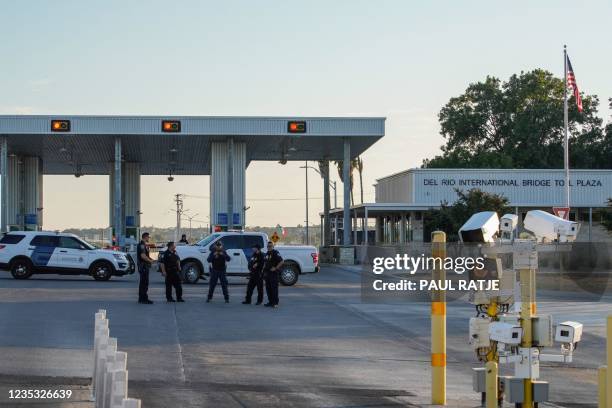 Customs and Border Protection agents guard the entrance to the Del Rio International Bridge, which is closed temporarily after an influx of migrants,...