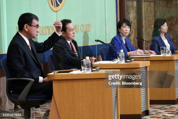 Taro Kono, Japan's regulatory reform and vaccine minister, left, speaks as Fumio Kishida, former foreign minister of Japan, from second left, Sanae...