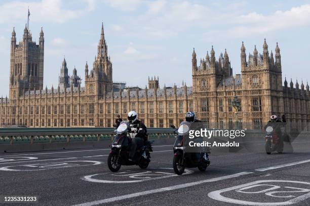 Electric motorbikes cross Westminster Bridge during London to Brighton Electric Vehicle Rally in London, United Kingdom on September 18, 2021....