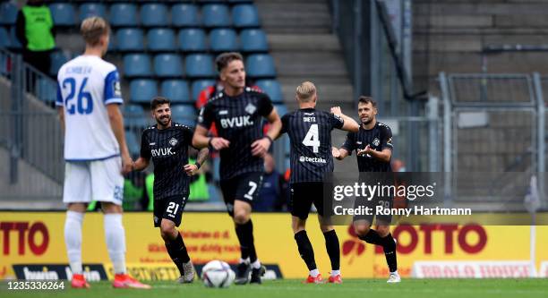 Robert Herrmann of Wuerzburg celebrates after scoring his team's second goal with Lars Dietz, Mirnes Pepic and Moritz Heinrich of Wuerburg during the...