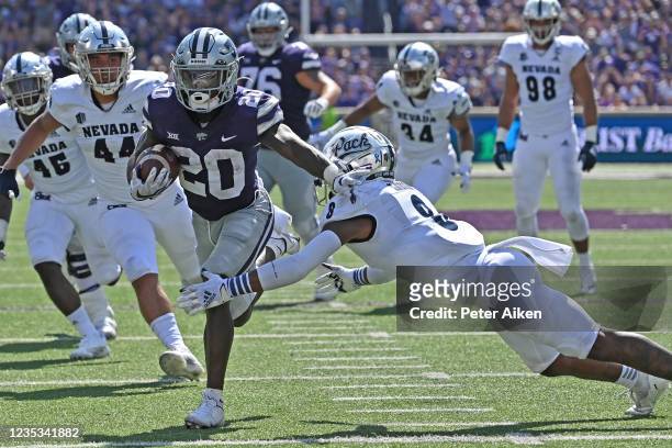 Running back Joe Ervin of the Kansas State Wildcats runs for a touchdown against safety JoJuan Claiborne of the Nevada Wolf Pack during the first...