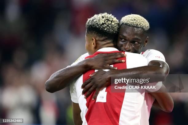 Ajax's Dutch forward David Neres celebrates with teammates Ajax's Danish forward Mohamed Daramy after wining the Dutch Eredivisie match between Ajax...