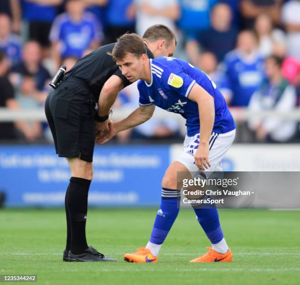 Referee Benjamin Speedie, left, and Ipswich Town's Tom Carroll during the Sky Bet League One match between Lincoln City and Ipswich Town at LNER...