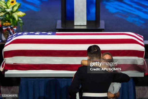 Shana Chappell, mother of slain Marine Kareem Nikoui, hugs a US marine next to the flag-draped casket of her son during a funeral ceremony at the...