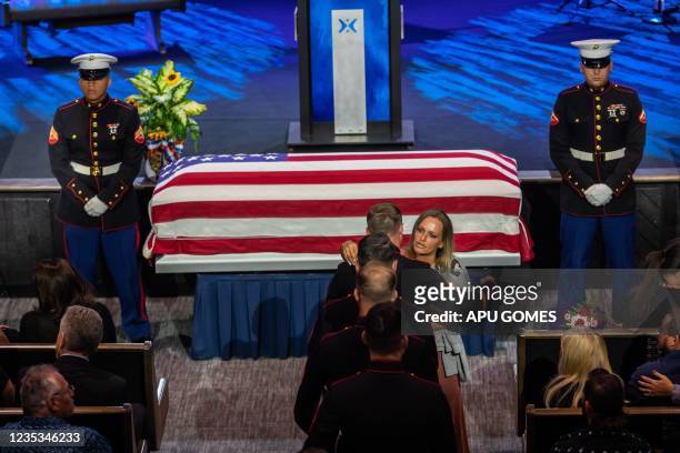 Shana Chappell, mother of slain Marine Kareem Nikoui, hugs a US marine next to the flag-draped casket of her son during a funeral ceremony at the...