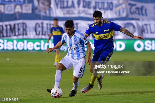 Abel Bustos of Atlético Tucumán and Nicolás Orsini of Boca Juniors fight for the ball during a match between Atlético Tucumán and Boca Juniors as...