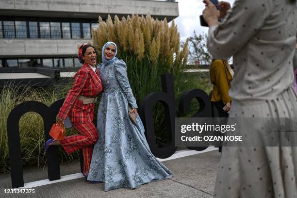 Fashionistas and influencers take pictures on September 14 during an event in Istanbul. - Halima Aden, the first supermodel to wear a hijab and pose...