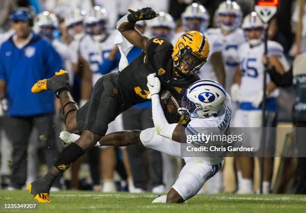 Rachaad White of the Arizona State Sun Devils is tackled by D'Angelo Mandell of the BYU Cougars during their game September 18, 2021 at LaVell...