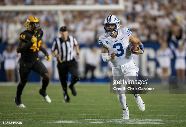 Jaren Hall of the BYU Cougars rushes the ball away from Travez Moore of the Arizona State Sun Devils during their game September 18, 2021 at LaVell...