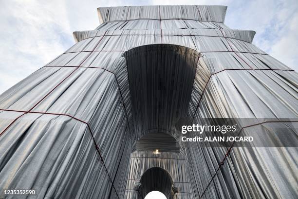 This photograph shows L'Arc de Triomphe, wrapped in silver-blue fabric, as it was designed by late artist Christo, in Paris as part of the 38th...