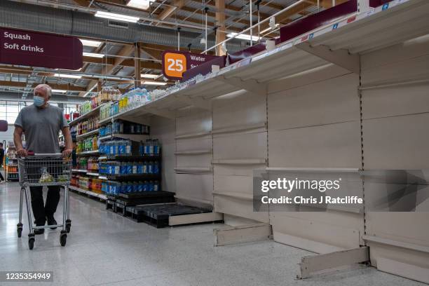 Empty shelves that usually stock bottled water at Sainsbury's supermarket, Greenwich Peninsular, on September 19, 2021 in London, England. Gaps in...