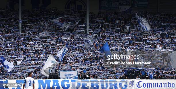 Supporters of Magdeburg cheer during the 3. Liga match between 1. FC Magdeburg and Wuerzburger Kickers at MDCC Arena on September 18, 2021 in...