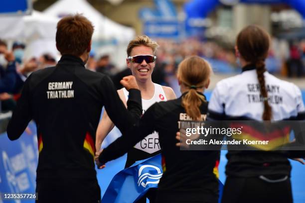 Tim Hellwig of Germany and the German team win the gold medal in the Mixed Relay race at the World Triathlon Championship Series Hamburg 2021 on...