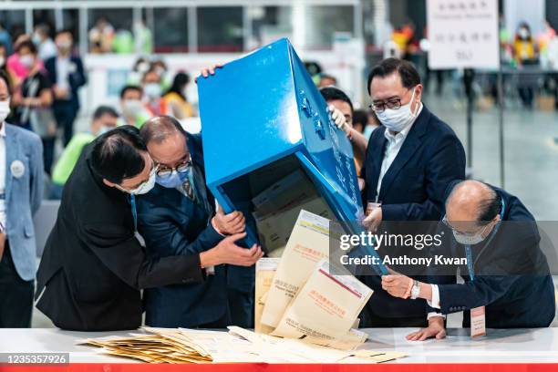 Government officials open a ballot box as vote counting starts at the Convention Centre, during the 2021 Election Committee Subsector Ordinary...