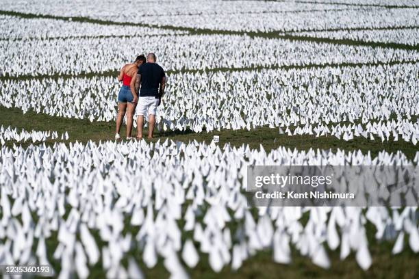 People visit the 'In America: Remember' public art installation near the Washington Monument on the National Mall on Saturday, Sept. 18, 2021 in...