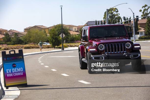 Attendees test drive a Jeep Wrangler 4xe plug-in hybrid electric vehicle during the Electrify Expo in Irvine, California, U.S., on Saturday, Sept....