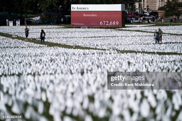 People visit the 'In America: Remember' public art installation near the Washington Monument on the National Mall on Saturday, Sept. 18, 2021 in...