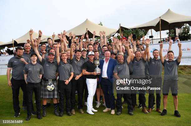 Kristoffer Broberg of Sweden poses with the Green-Keepers at the 18th green with the Trophy after winning the Dutch Open at Bernardus Golf on...