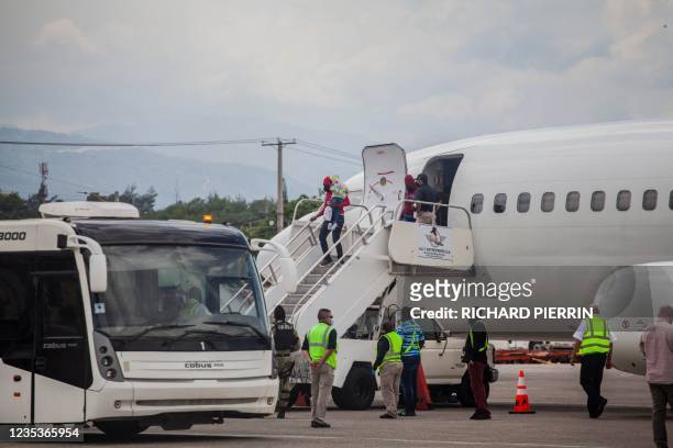 Expelled migrants arrive on September 19, 2021 at the airport in Port au Prince on September 19, 2021. - After weeks on the road, traversing...
