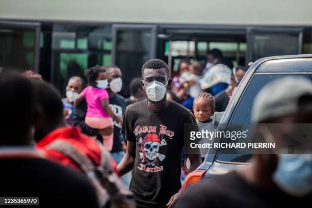 An expelled migrant arrives on September 19, 2021 at the airport in Port au Prince on September 19, 2021. - After weeks on the road, traversing...