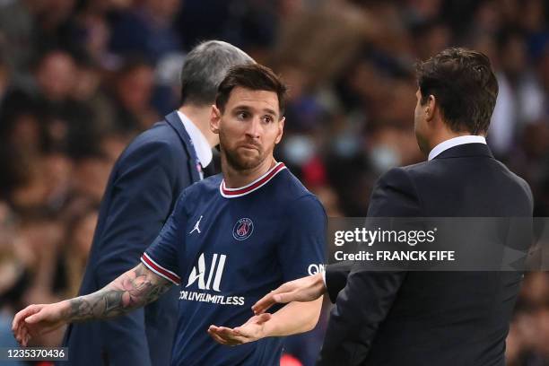 Paris Saint-Germain's Argentinian forward Lionel Messi looks at Paris Saint-Germain's Argentinian head coach Mauricio Pochettino as he leaves the...