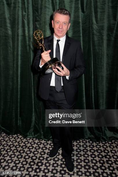 Peter Morgan accepts the award for outstanding Writing For A Drama Series for The Crown attends the Netflix celebration of the 73rd Emmy Awards at...