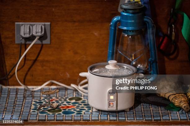 This picture taken on September 19, 2021 shows a rice cooker plugged in inside campervan enthusiast Takayuki Minagawa's 1964 Volkswagen Type 2 at a...