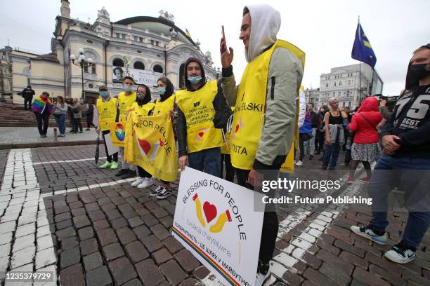 Activists stand on Volodymyrska Street near the National Opera House during the Equality March carried out in support of the LGBTQ community under...