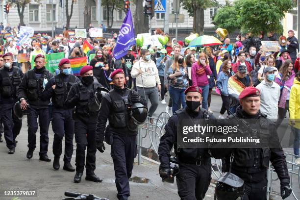 Police officers accompany the participants of the Equality March carried out in support of the LGBTQ community under the slogan 'Side by Side to...