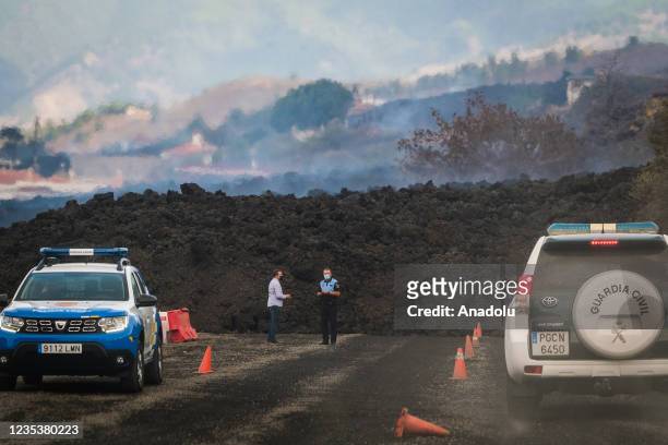 Security forces take measures as Mount Cumbre Vieja continues to erupt in El Paso, spewing out columns of smoke, ash and lava as seen from Los Llanos...
