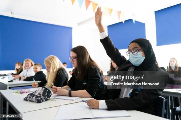 Child raises their hand during a maths lesson at Llanishen High School on September 20, 2021 in Cardiff, Wales. All children aged 12 to 15 across the...