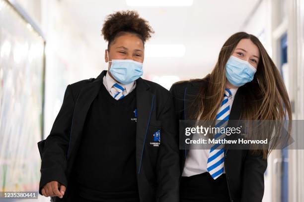 Children wearing face masks walk down a corridor at Llanishen High School on September 20, 2021 in Cardiff, Wales. All children aged 12 to 15 across...