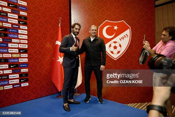 Turkey national football team's newly appointed, German head coach Stefan Kuntz poses with Turkish football board member of Turkish football...