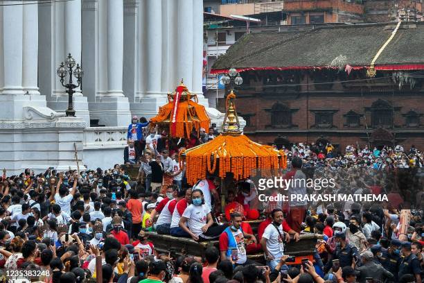 Spectators gather to observe the procession as devotees pull the chariot carrying the Hindu gods Bhariab , Kumari , on the fourth day of the Indra...