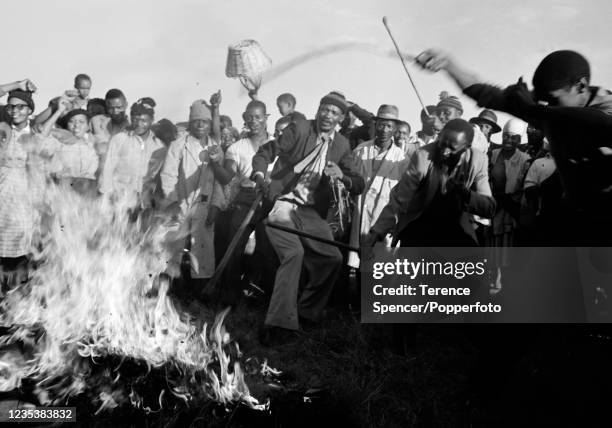 Residents from the township of Sharpeville burn their pass books during a demonstration against government pass laws as part of a day of protest at...