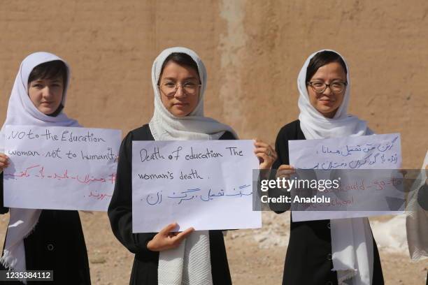 Number of girls in Herat gather to stage a demonstration demanding to continue their education in schools and universities, on September 20, 2021 in...