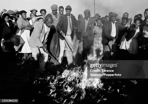 Residents from the township of Sharpeville burn their pass books during a demonstration against government pass laws as part of a day of protest at...