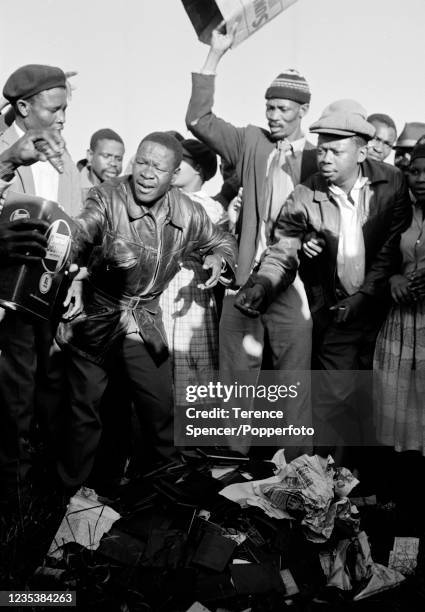 Residents from the township of Sharpeville burn their pass books during a demonstration against government pass laws as part of a day of protest at...