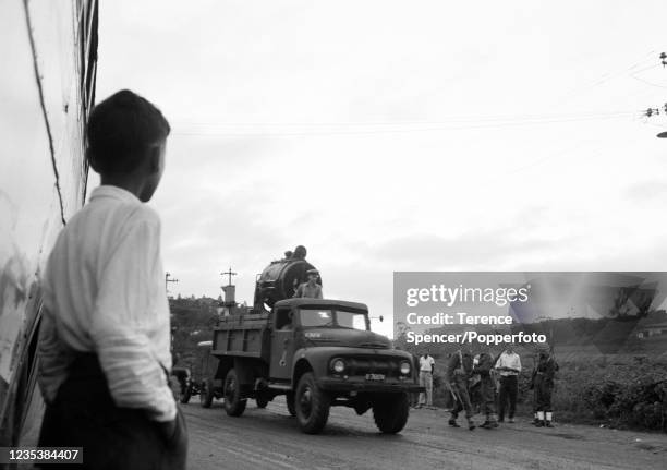 Armed South African police prepare to attempt to regain order as protestors from the township of Sharpeville demonstrate against government pass laws...