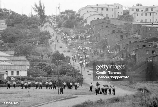 South African police advance in an attempt to regain order as protestors from the township of Sharpeville demonstrate against government pass laws...